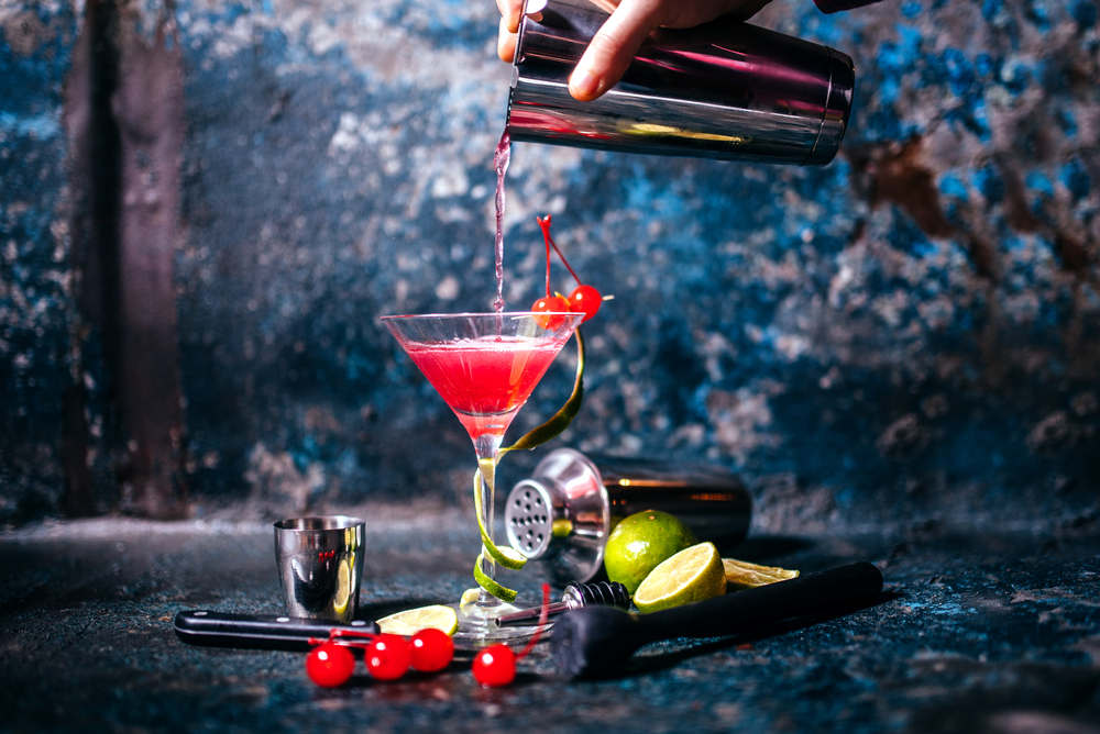 Barman,Preparing,And,Pouring,Red,Cocktail,In,Martini,Class.,Cosmopolitan